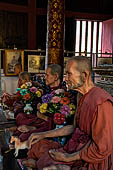 Chiang Mai - The Wat Phra Singh temple. The ubosot (ordination hall). Detail of the ku, a large ornate Buddha throne that sits in the middle of the building. 